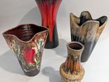 three vases that are sitting on a white surface