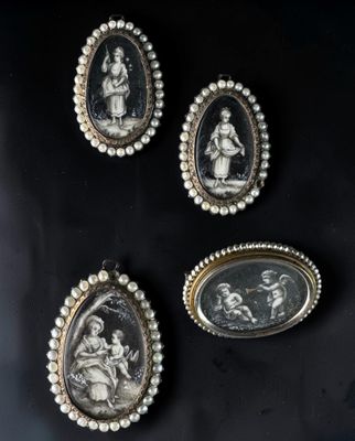 a group of three oval cameos of women and children