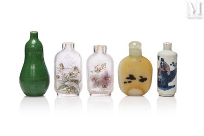 several different colored glass bottles are lined up on a white surface