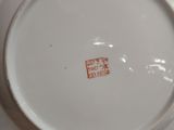 a white plate with a red stamp on it