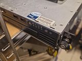 a computer on top of a metal rack in a room