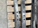 four wrenches are sitting on a pallet in a warehouse