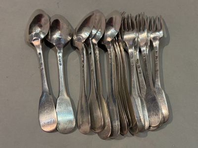 six spoons and a fork on a table