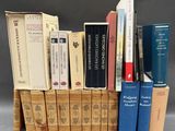 several books are stacked on top of each other on a table