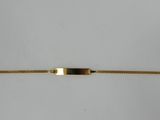 a close up of a gold bracelet with a bar on it