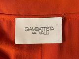 a label on an orange shirt that says gambattita