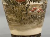 a vase that has flowers on it on a table