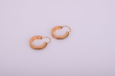 une paire de boucles d'oreilles en or sur fond blanc