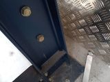 a metal door that is open in a room