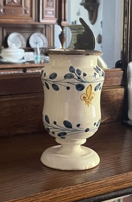 un vase blanc et bleu posé sur une étagère en bois