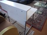 a white table with a glass top in a living room