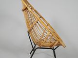 the chair is made of bamboo and has a black metal frame