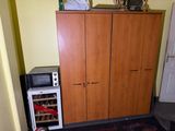 a microwave and a refrigerator in a small room