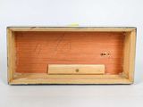 a wooden box with a piece of wood in it