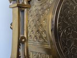 a gold clock that is sitting on a table
