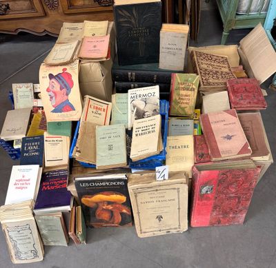 many books stacked on top of each other on the floor