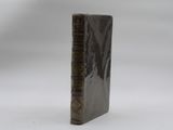 an old book sitting on top of a table next to a white background
