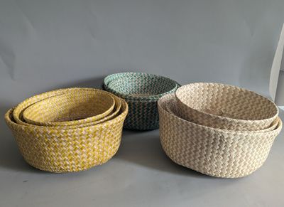 three woven baskets sitting on top of a table next to each other