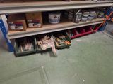 a shelf full of paint and other items in a room