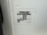 an image of a white refrigerator with a sticker on it