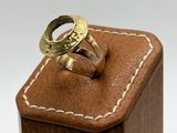 a wooden box with a ring on top of it
