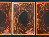 three cards of different colors and designs on a blue background