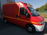 an image of a red van parked in a parking lot