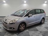 a picture of a small silver car parked in a garage