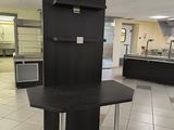 a kitchen with a table and a refrigerator in it