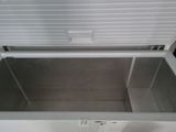 a white chest with a lid open on the floor