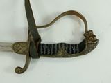 a sword that is laying on a white surface