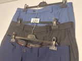 three pairs of pants hanging on a hanger