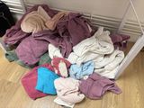 a pile of clothes on the floor next to a table