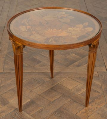 a small table with a glass top on a wooden floor