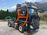 a black and orange truck parked on the side of the road