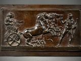 a bronze plaque with a horse and carriage on it