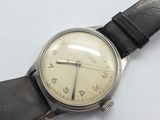 a watch that is sitting on a white surface