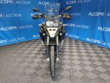 a picture of a motorcycle parked in front of a blue wall