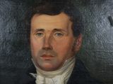 portrait of a man in a black suit and white shirt