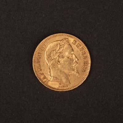 gros plan d'une pièce d'or sur une surface noire
