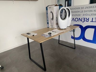 a table with a washing machine on it in front of a sign