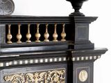 a black and gold cabinet with a clock on top