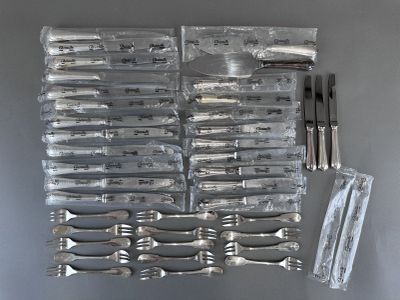 a lot of silverware on a table with a fork and knife