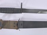 two different types of knives on a white surface