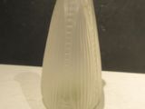 a glass vase sitting on a table with a black background