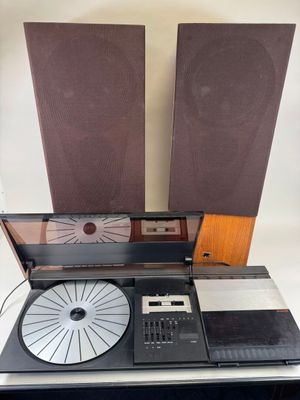 two speakers and a record player sitting on a table