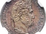 a close up of a coin on a white surface