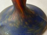a vase that is sitting on a table with writing on it