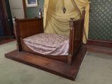 a bed with a canopy in the middle of a room