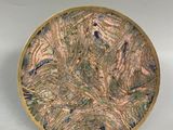a picture of a gold plate with a design on it